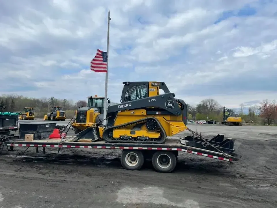 Compact track loader on a tandem trailer, ready to haul to the next job site